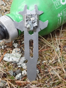 a magnetic tool with grains of local ferrous rock stuck to it.