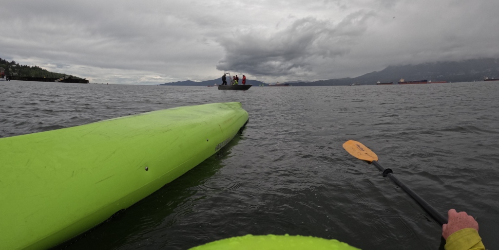 a capsized kayaker's view of the approaching rescue boat